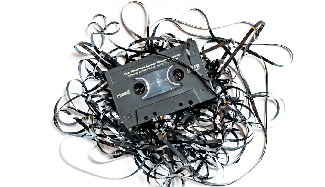 a pile of black and white wires and a cassette a pile of black and white wires and a cassette