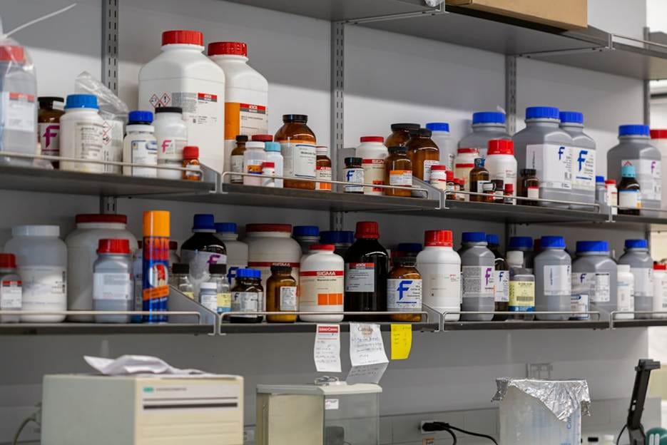 Laboratory shelves filled with chemical bottles.