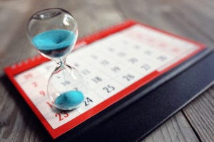 Hourglass on top of calendar 