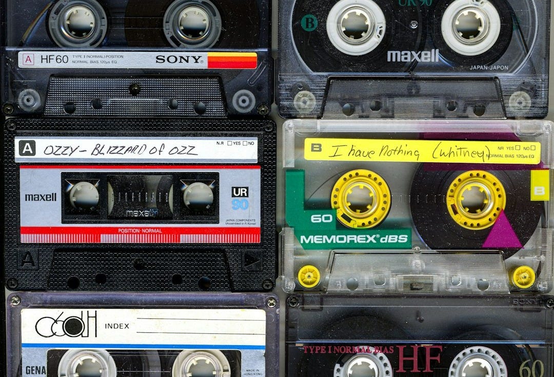 a collection of cassette tapes stacked on top of each other