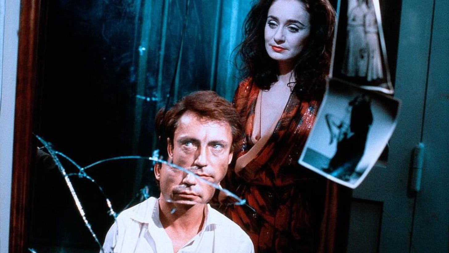Seduction: The Cruel Woman | Still features | Still features Udo Kier kneeling below Mechthild Großmann. Seduction: The Cruel Woman | Still features | Still features Udo Kier kneeling below Mechthild Großmann.