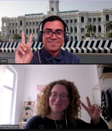 Screenshot of a man and woman conversing, holding up the peace sign.