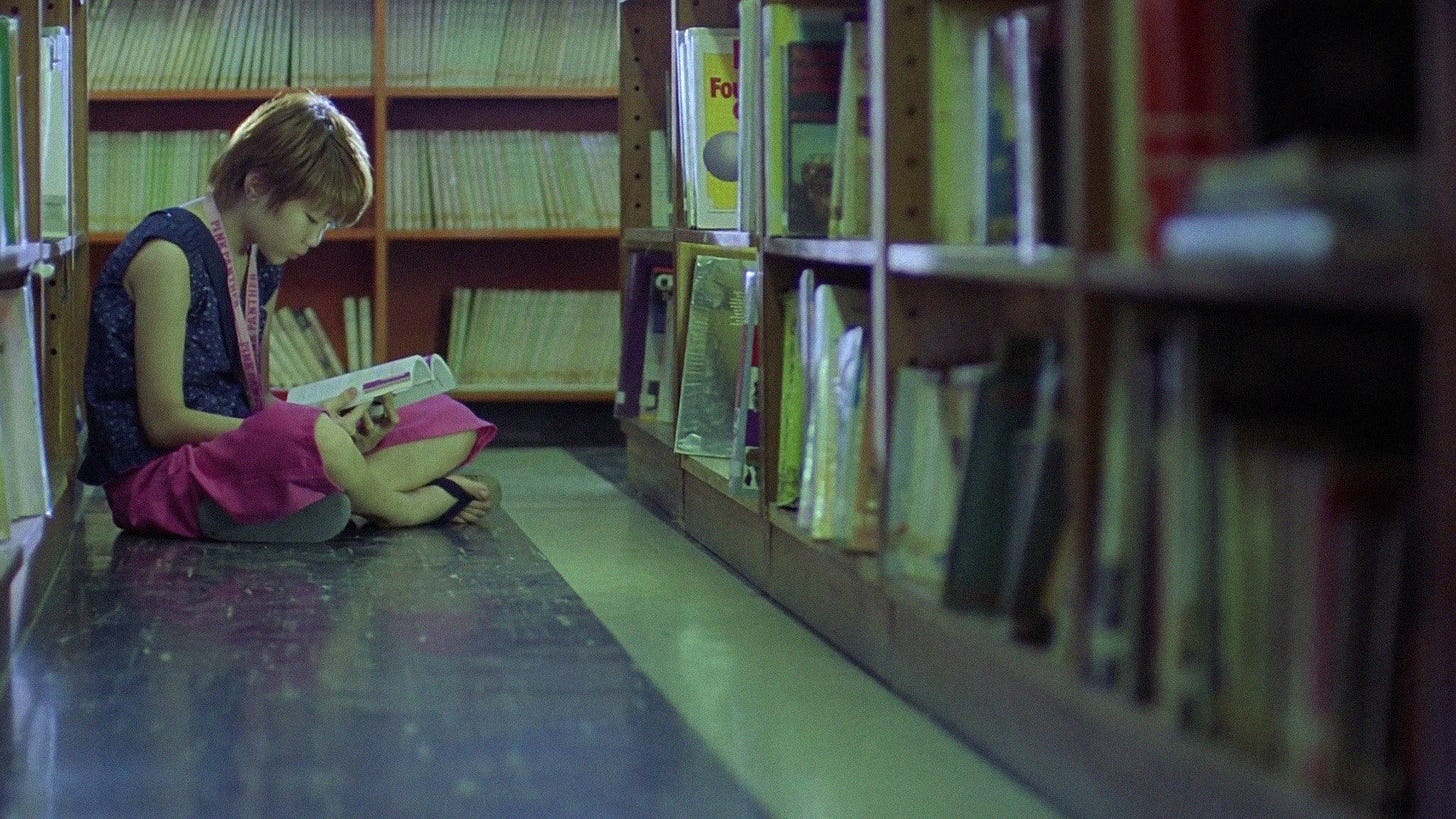 Spacked Out | Still features a young girl sitting alone in a library.