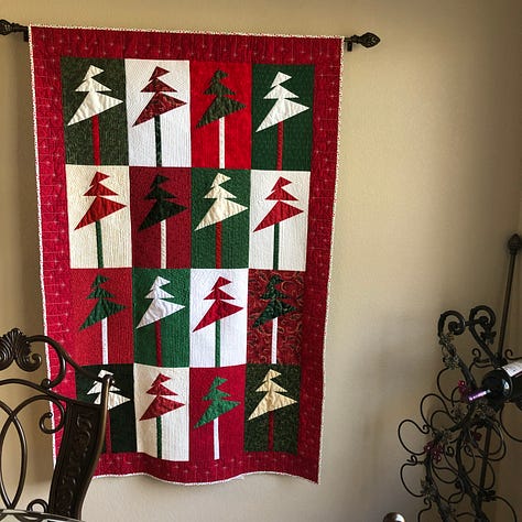 A collection of ornaments and quilted decorations in red, green and sparkling white.