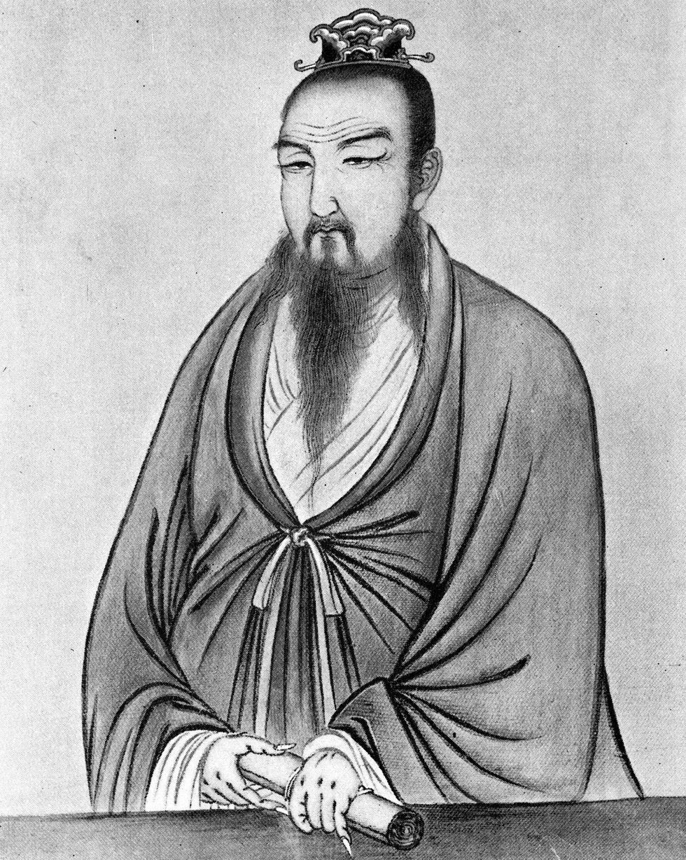 drawing of a man with a long goatee that stretches to the middle of his chest, he wears robes and and ornament on the top of his head and holds a scroll with both hands