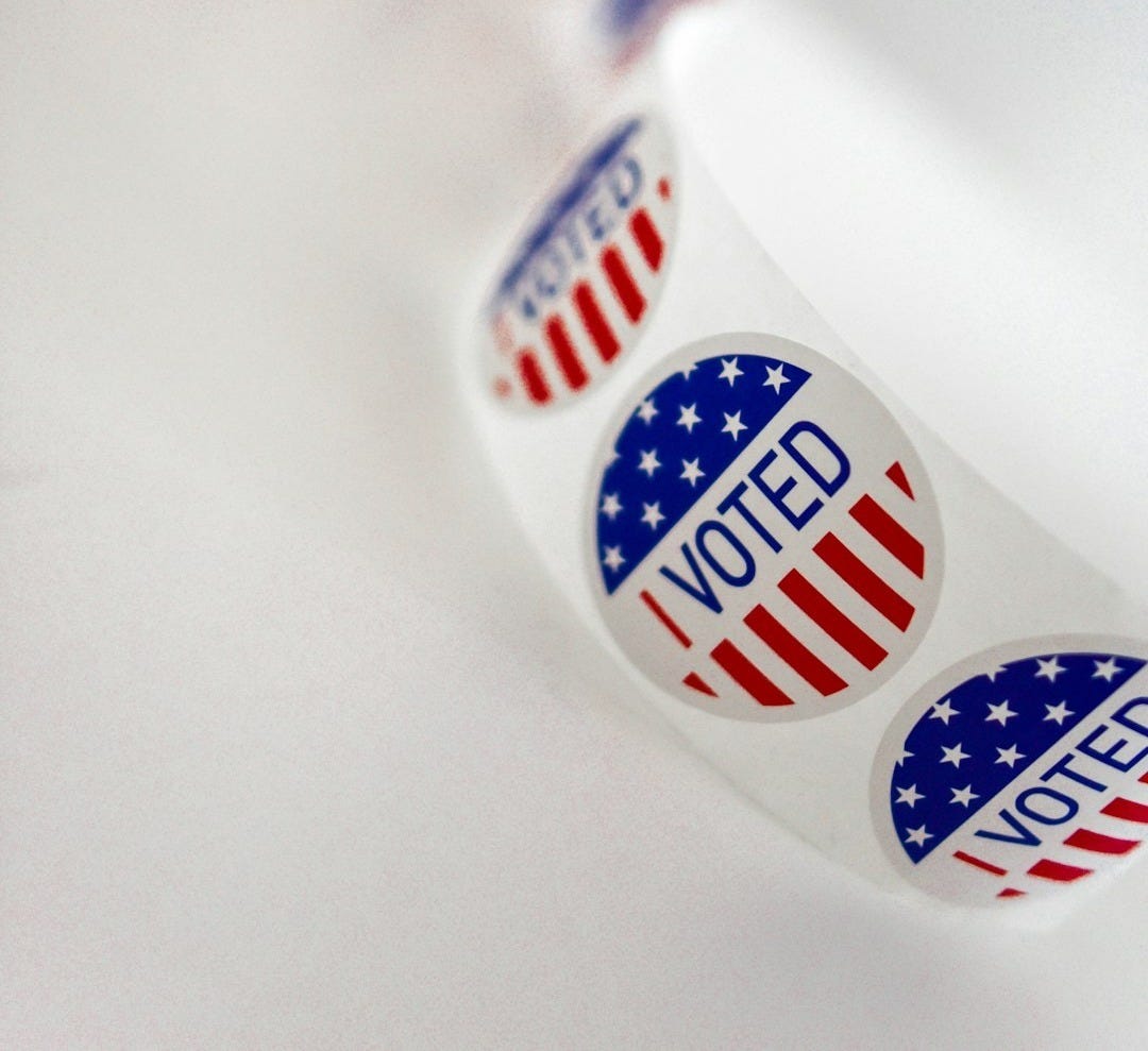 a close up of a toothbrush with the word vote written on it