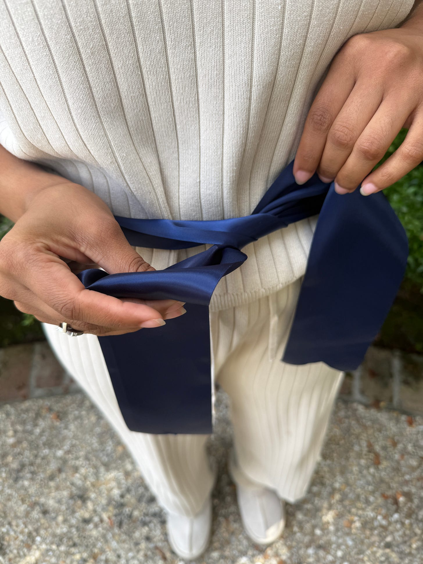 Creating the first loop with the bottom piece of navy ribbon