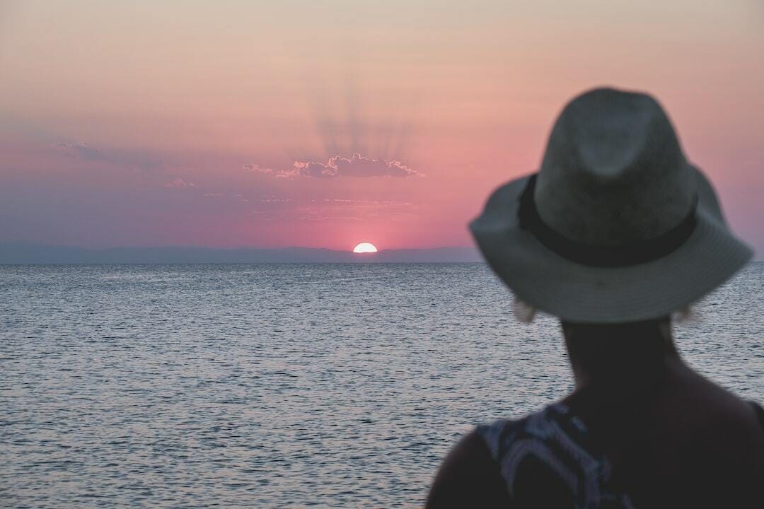 woman facing sunset woman facing sunset