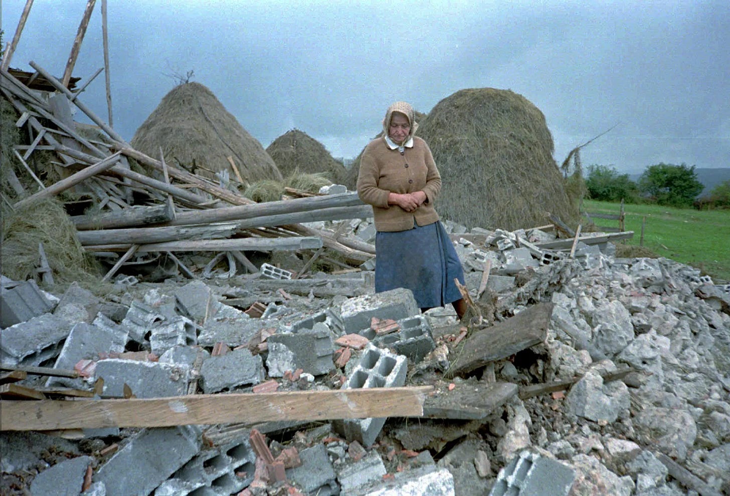 An unidentified Serb woman inspects debris of her home, destroyed in NATO air-strikes in the village of Vidrici, near Sokolac, some 50 kms northeast of Sarajevo Wednesday Aug 30 1995 An unidentified Serb woman inspects debris of her home, destroyed in NATO air-strikes in the village of Vidrici, near Sokolac, some 50 kms northeast of Sarajevo Wednesday Aug 30 1995