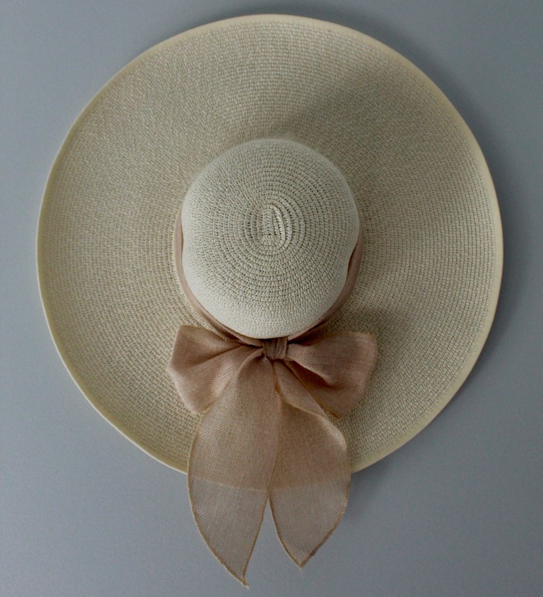 beige hat on white surface beige hat on white surface