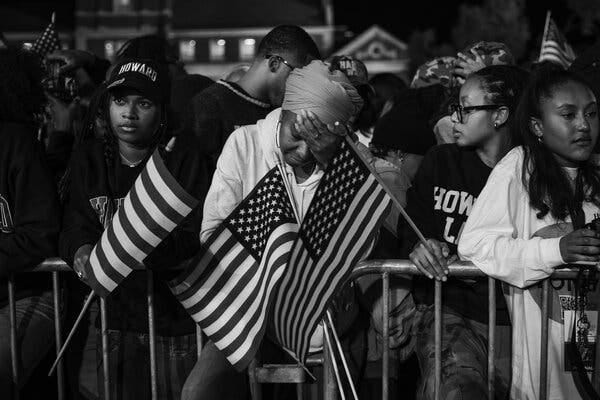 A black and white photograph of Kamala Harris supporters watching the election results with dismay on their faces. A black and white photograph of Kamala Harris supporters watching the election results with dismay on their faces.