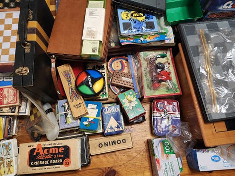 Carved horse, wooden snake, record player, wall map, dragon kite, games, brass lamp, Lego flowers, mirror, globe, lava lamp, books, football player figures, hourglass, typewriter.