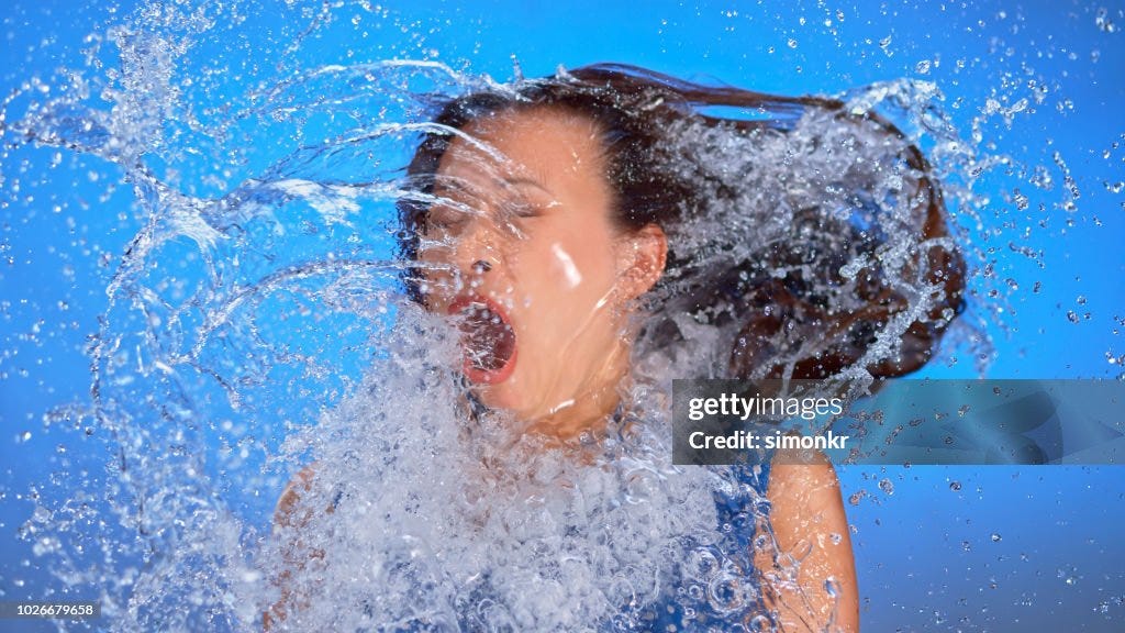 Woman Being Splashed With Water High-Res Stock Photo - Getty Images
