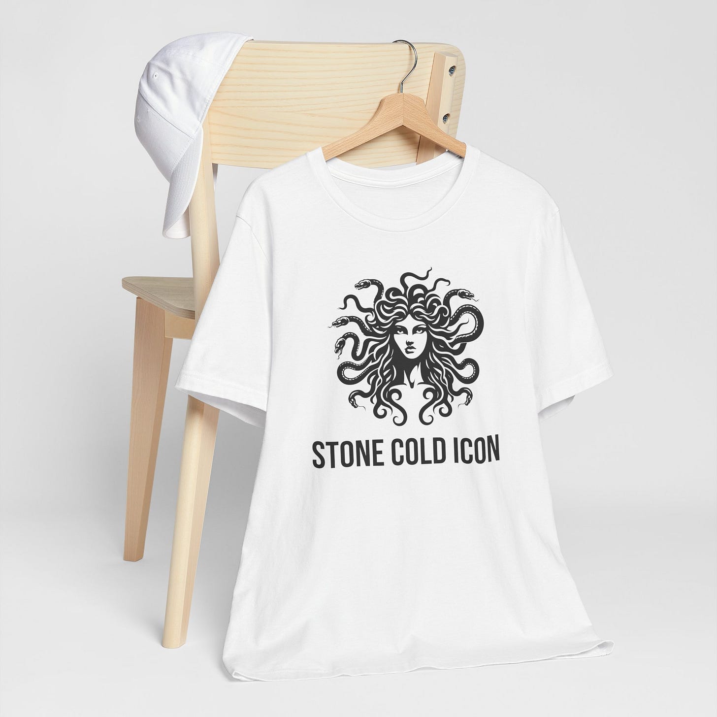 Stone Cold Icon T-Shirt – Medusa Shirt, Greek Mythology Shirt, Unisex Tee, Literary Gift, Bookworm Shirt, Ancient Greece Inspired Clothing, Nerd Gift, Mythology Lover, Booklover Tee product main image t-shirt featuring a bold Medusa emblem with the text “Stone Cold Icon” underneath, combining mythic power and modern style. Perfect for mythology lovers and fashion icons alike.