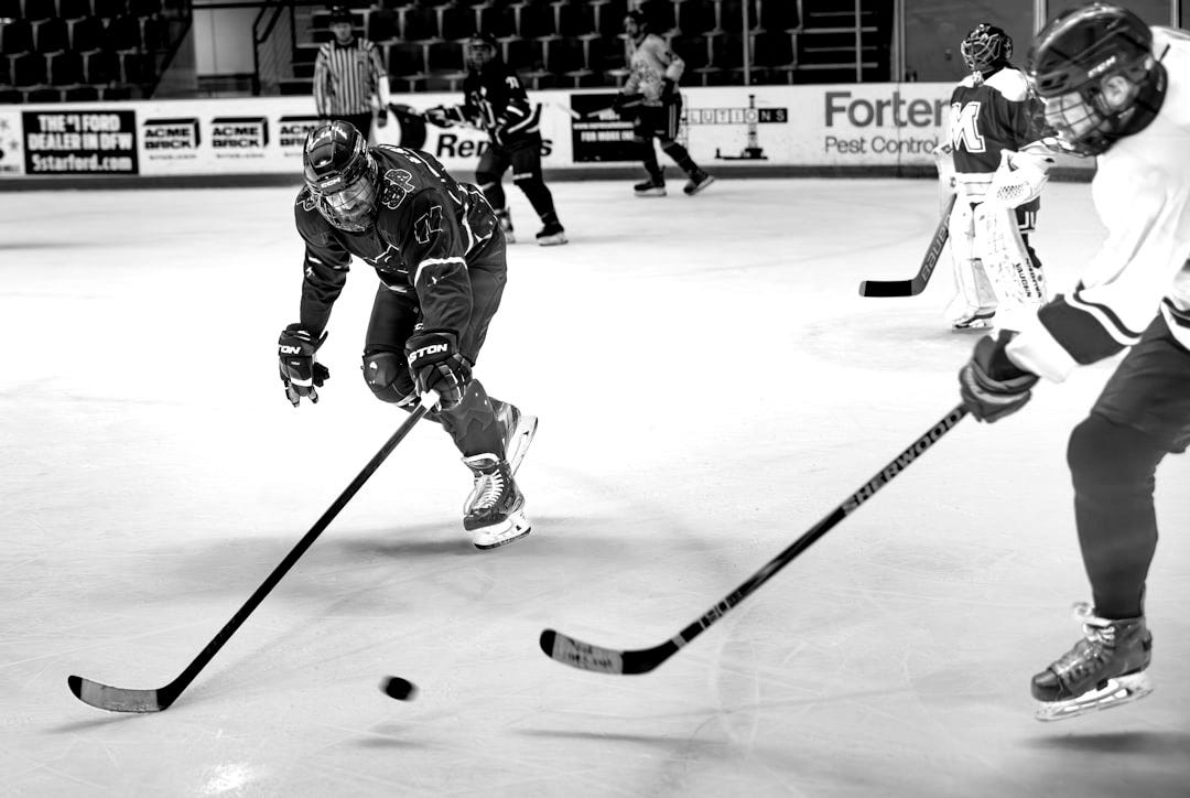 A group of young men playing a game of ice hockey