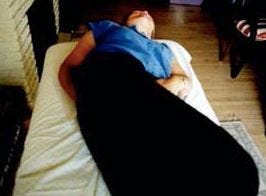 lady laying down holding chakra points lady laying down holding chakra points