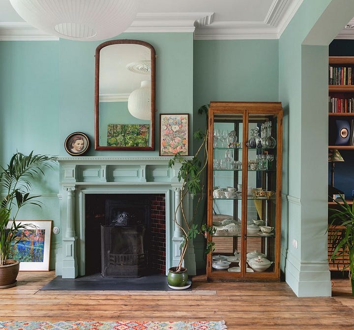 wall paint, architraves, wooden flooring, fireplace, sisal rugs, velvet sofa, pendant light, curtains