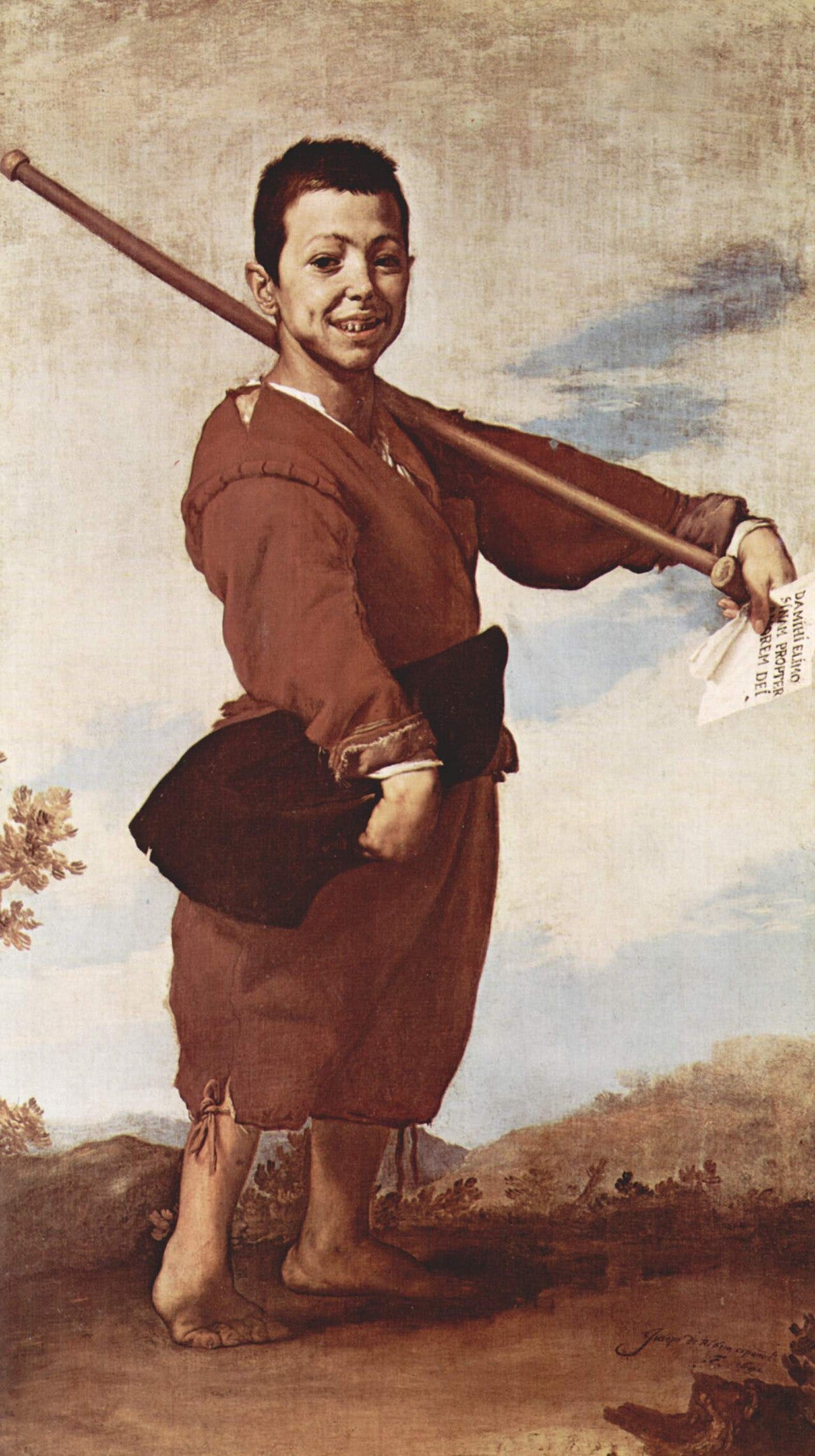 Grinning boy with a crutch holding a scrap of paper Grinning boy with a crutch holding a scrap of paper