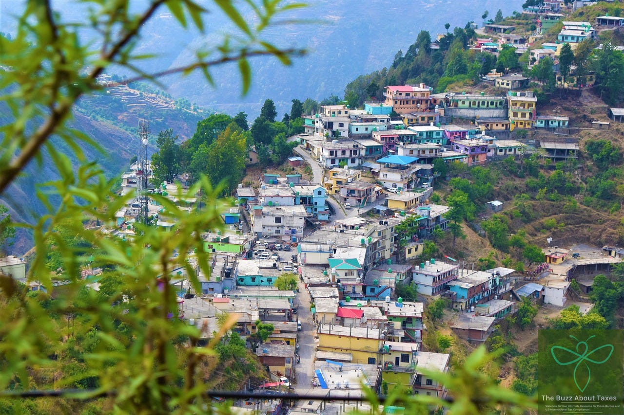 Picture of a hillside with homes. Picture is from Mussorie in India. 