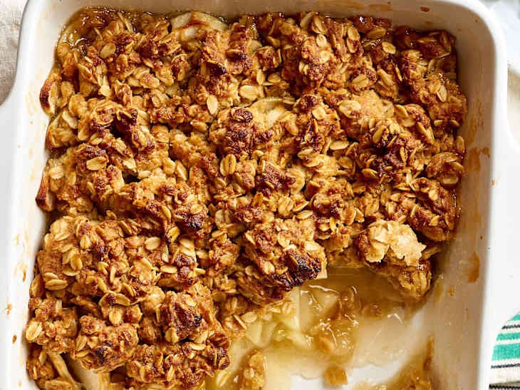 Apple crisp topped with buttery oats in a baking pan Apple crisp topped with buttery oats in a baking pan