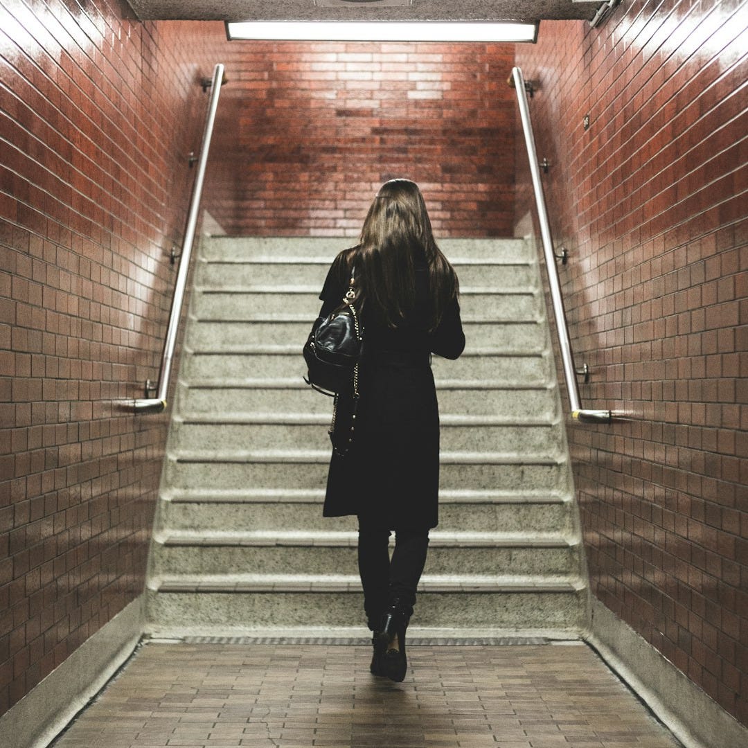 woman walking near staircase