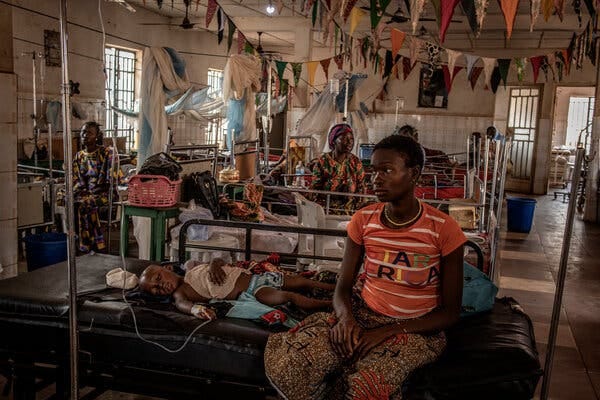 Fudia Kamara, 25, sat with her son Kabba Kargbo, 3, in the hospital in Kamakwie, Sierra Leone. Like nearly all the children in the pediatric ward, he had malaria.