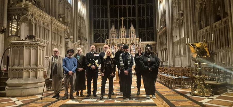 A group of people standing in a church

AI-generated content may be incorrect.