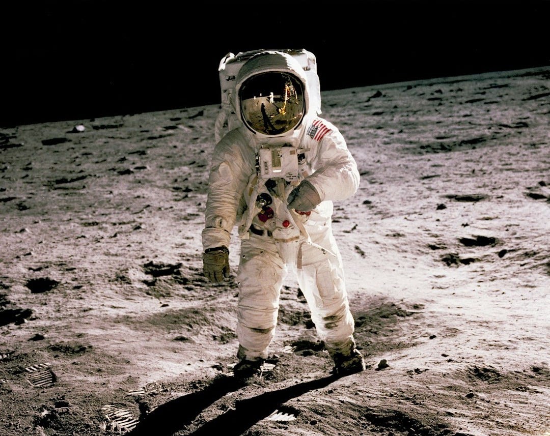 astronaut standing on gray sand astronaut standing on gray sand