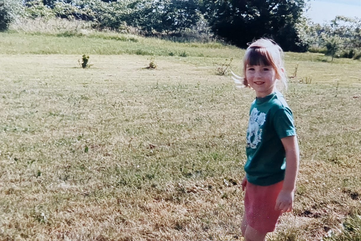 Little girl looking happy in a field Little girl looking happy in a field