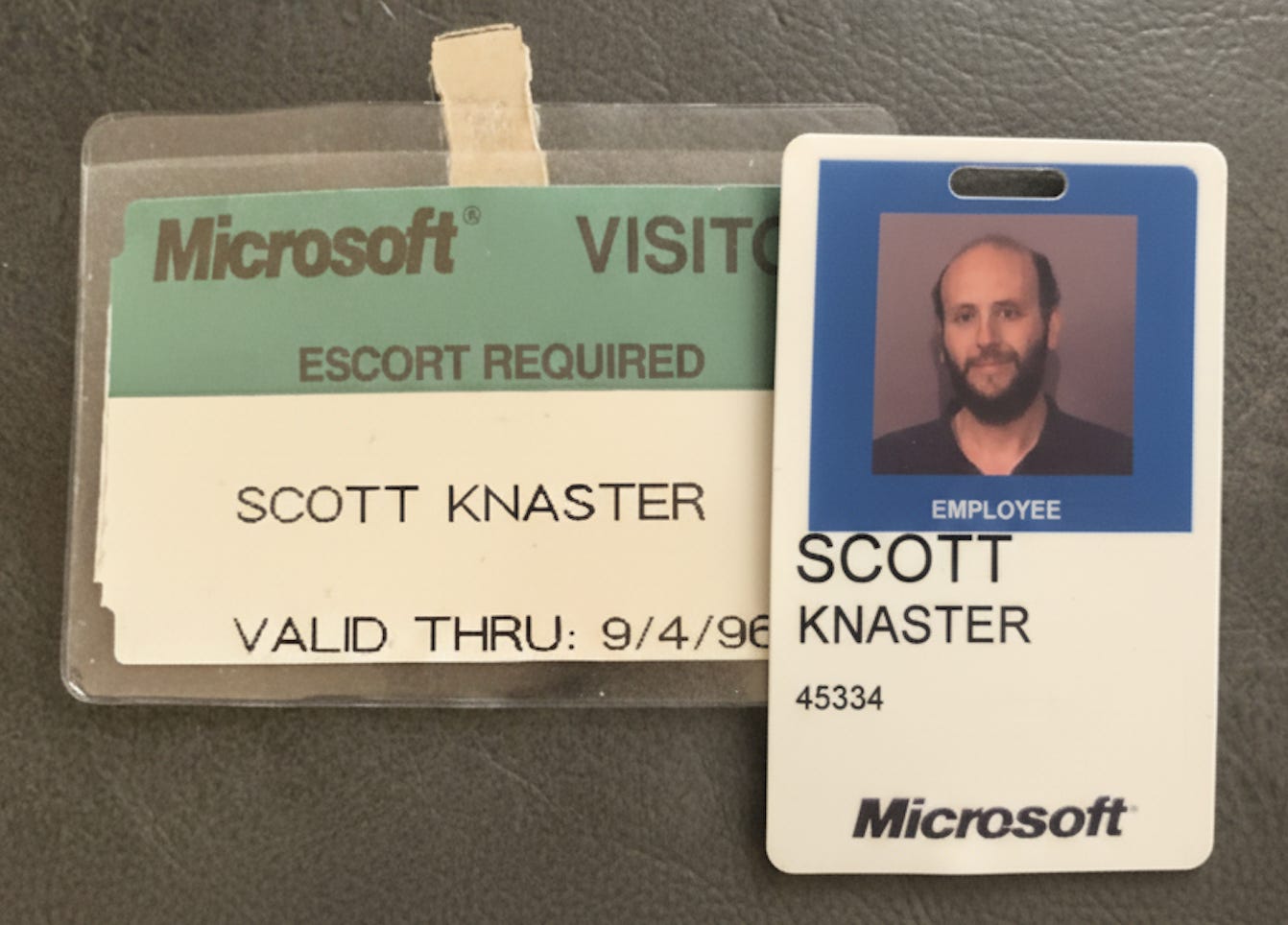 On the left is a Microsoft visitor badge for Scott Knaster. On the right, Scott Knaster's Microsoft employee badge. He's looking really thin there.