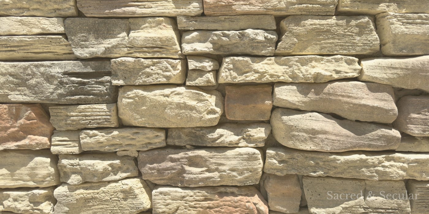 A weathered stone wall in warm natural light, suggesting age, stillness, and the lasting impact of words.