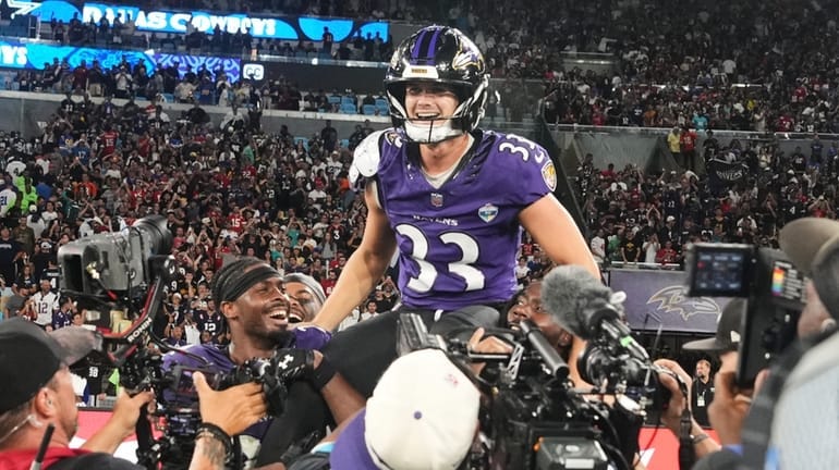 Baltimore Ravens place kicker Tyler Loop (33) celebrates after winning...