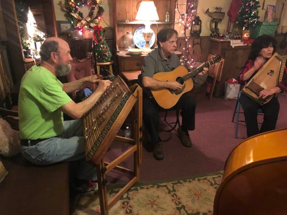 May be an image of 3 people, people standing, guitar and indoor