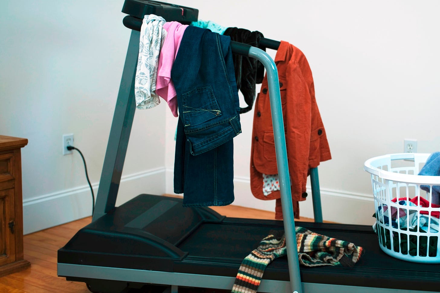 Home treadmill being used to hold laundry.