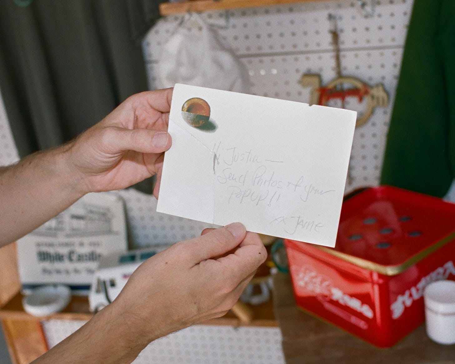 A note from Jaine to Justin on a JG Melon postcard