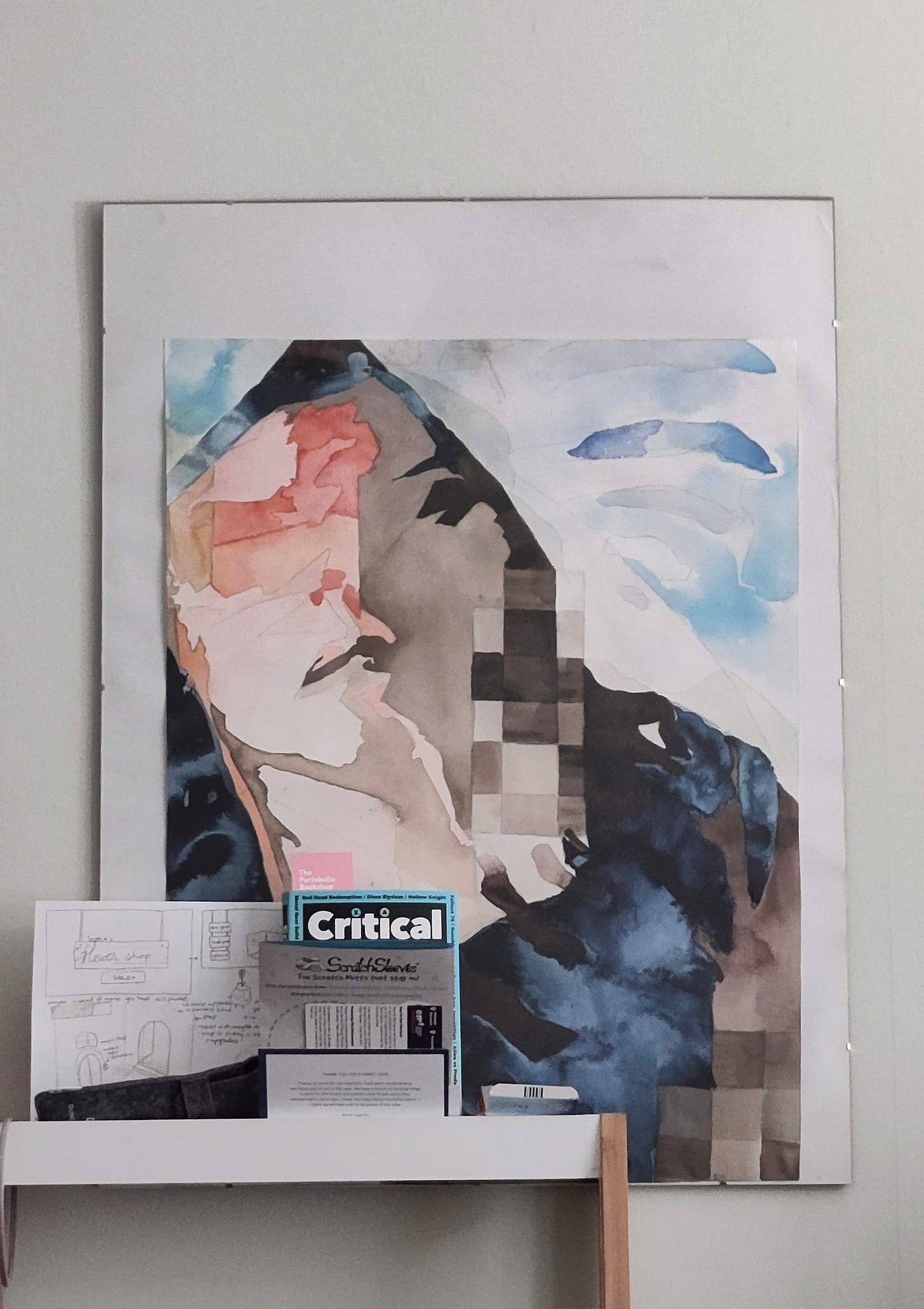 A picture of a large abstract watercolor painting hung on a wall behind a bookshelf A picture of a large abstract watercolor painting hung on a wall behind a bookshelf