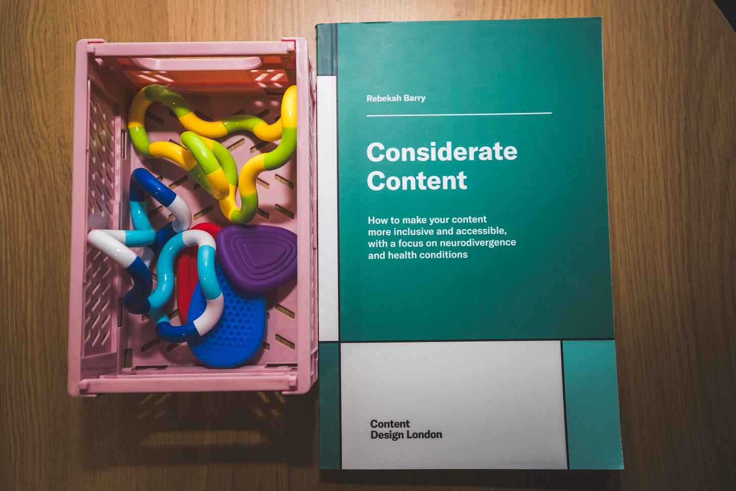 A box of fidget toys, next to a book entitled "Considerate Content"