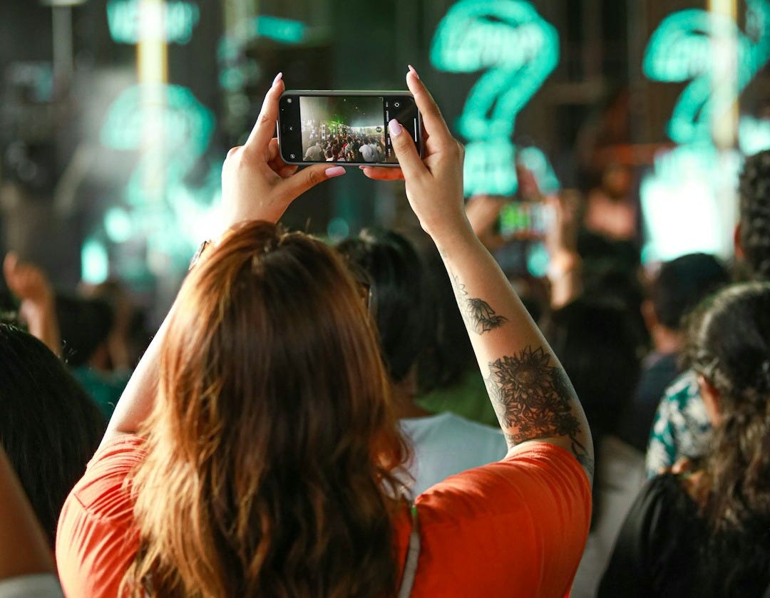 a person taking a picture of a crowd