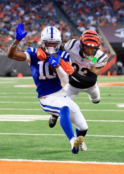 Adonai Mitchell of the Indianapolis Colts scores a touchdown while defended by Daijahn Anthony of the Cincinnati Bengals during the first quarter of...