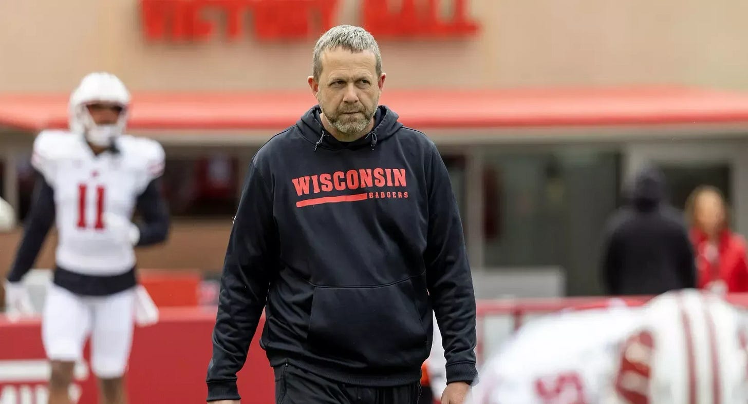 Wisconsin Badgers outside linebackers coach Matt Mitchell walking on the field during practice.