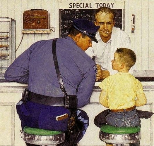 This may contain: two men and a little boy sitting at a counter This may contain: two men and a little boy sitting at a counter