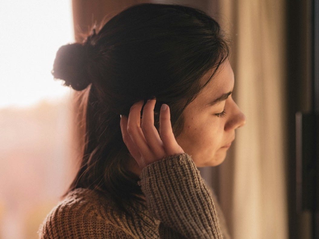 selective focus photography of woman touching hair selective focus photography of woman touching hair