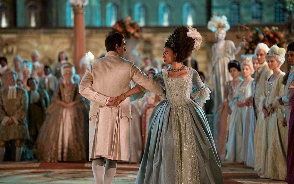 Still from the show, depicting Charlotte and George dancing in a crowd of aristocrats.