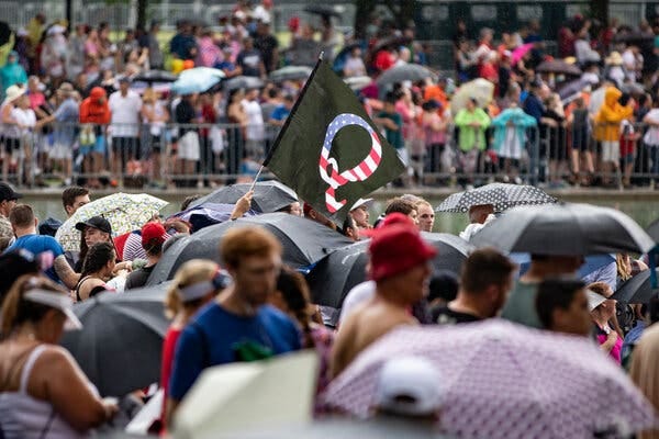 A QAnon flag above the crowd along the National Mall at an Independence Day celebration in Washington in 2019. A QAnon flag above the crowd along the National Mall at an Independence Day celebration in Washington in 2019.
