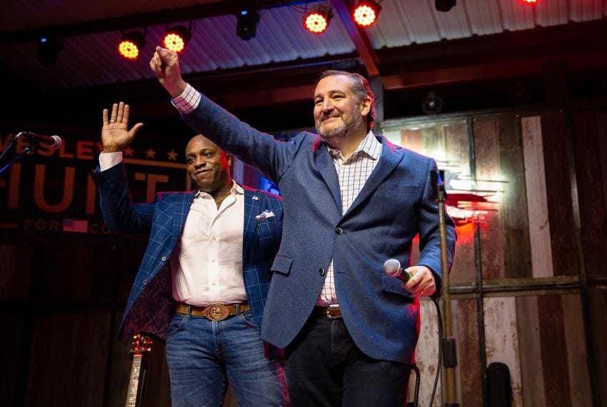 Senator Ted Cruz (R-TX) and Wesley Hunt, a Republican candidate for U.S. House Texas District 38, wave to a crowd at a rally in Houston on Monday, Jan. 17, 2022.