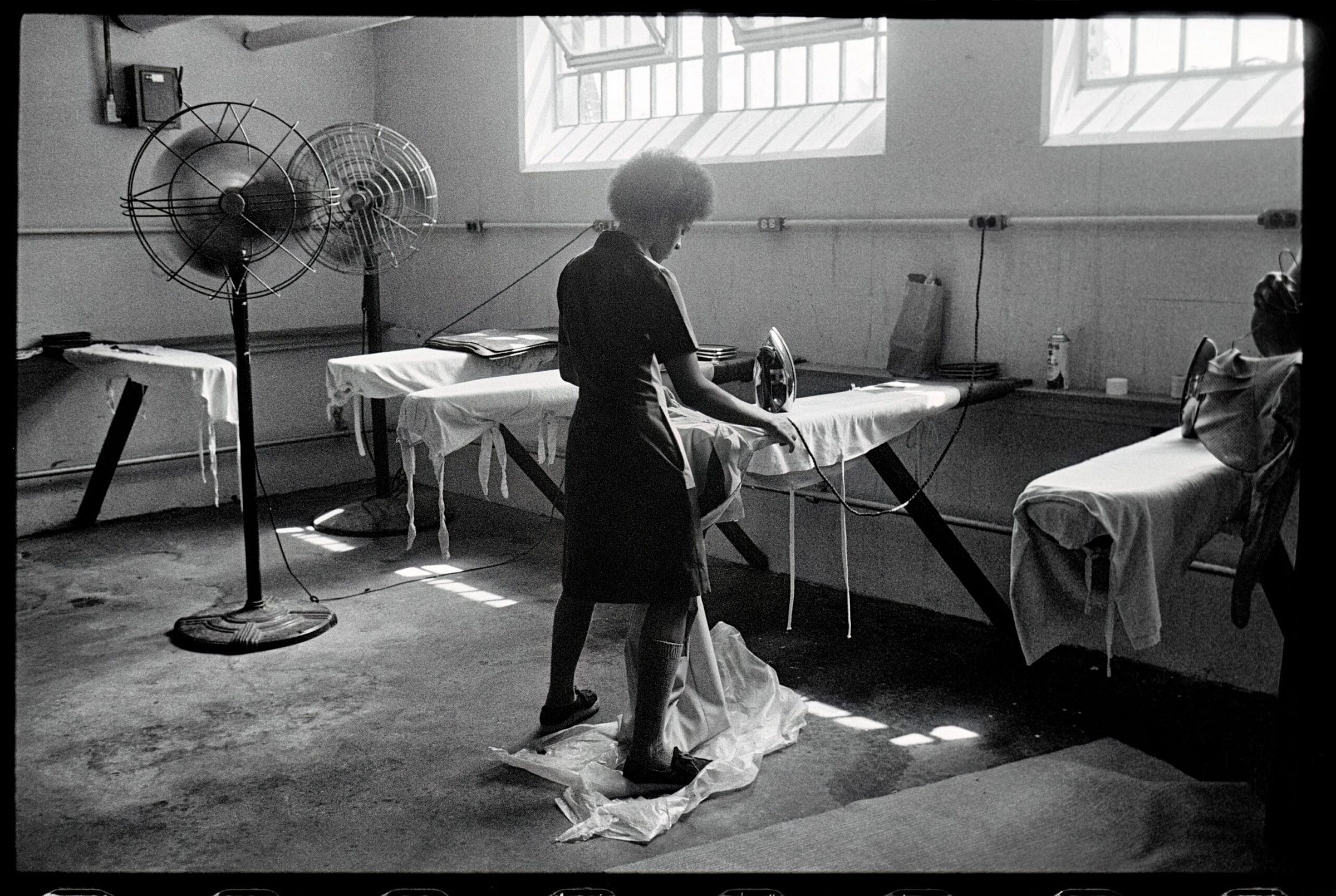 Phyllis, a prison inmate, ironing in a penitentiary basement, Louisville, USA. Melissa Farlow