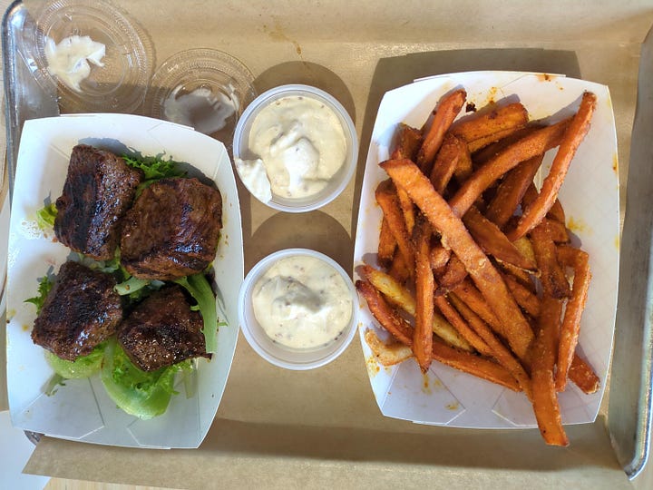 Menu board, interior, rice bowl, and steak skewer with sweet potato fries