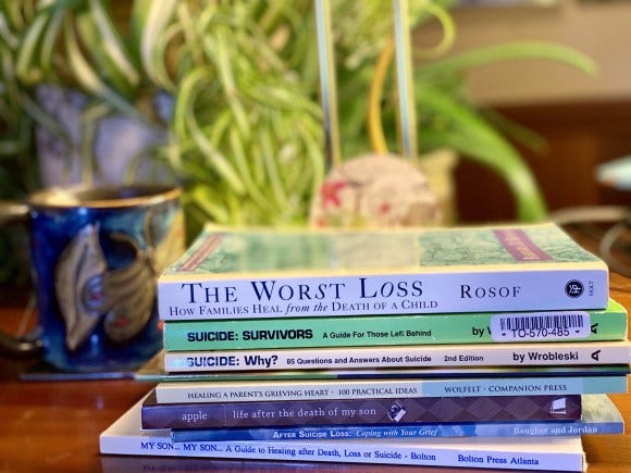 Photo of a stack of books about suicide loss, photographed for My Forever Son, Suicide is Not a Choice-Surviving Your Child's Suicide