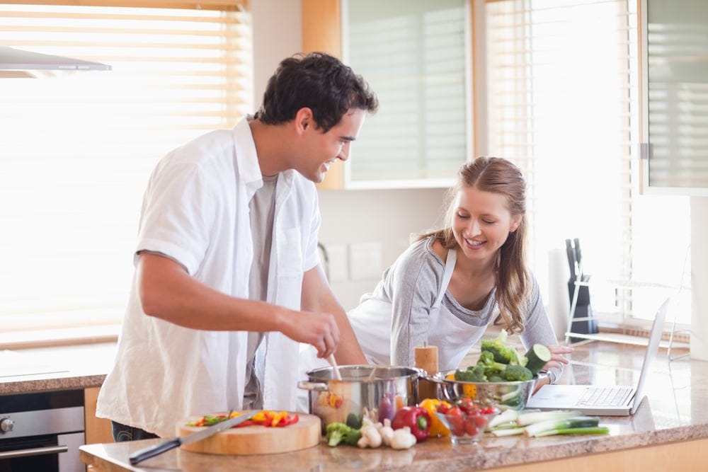 Young couple using the internet to look up recipe Young couple using the internet to look up recipe