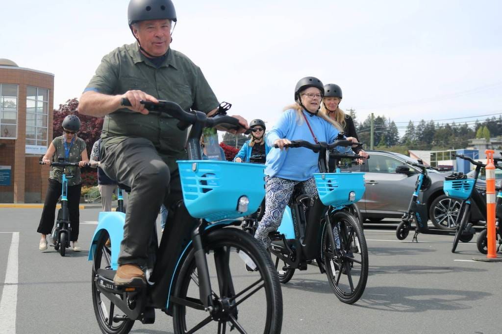 Couns. David Grove and Cynthia Day test drive e-bikes at the launch of the Evolve e-bike and e-scooter share program in Colwood.(Ben Fenlon/Goldstream Gazette)